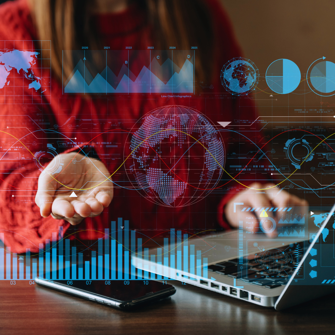 A person in a red sweater extends their hand over a laptop, with various digital graphs and charts displayed around them, representing data analysis and collaboration.